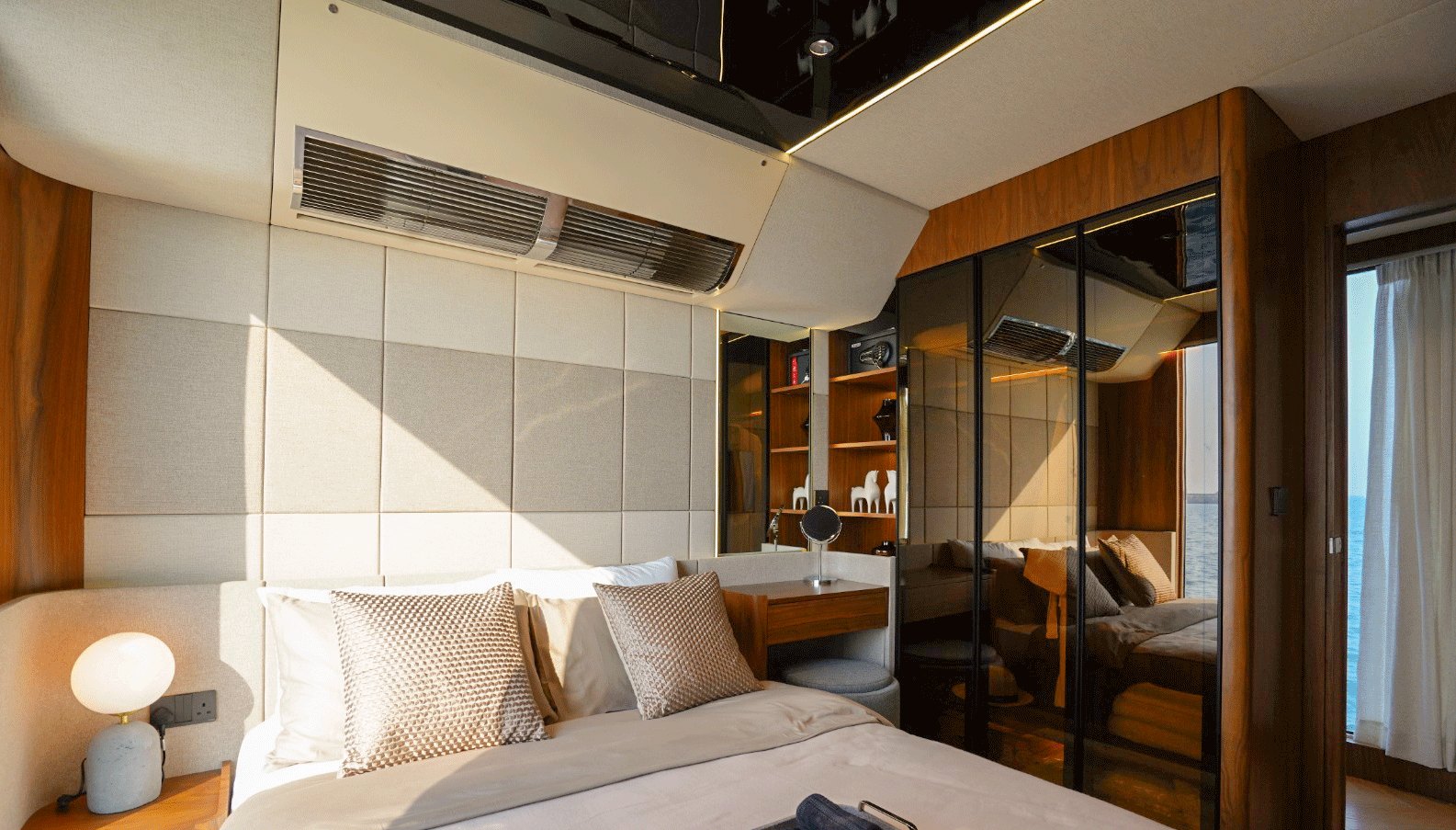 NERO 75 master bedroom with a double bed, timber wardrobes and upholstered walls